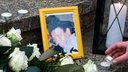 Ein Bild von Oury Jalloh, daneben Kerzen und Blumen, ähnlich einem Grab