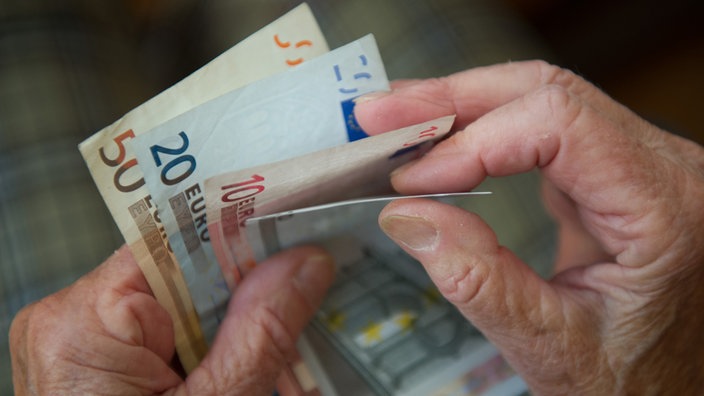  Eine ältere Frau zählt Geld