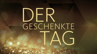 Goldener Schriftzug "Der geschenkte Tag" auf anthrazitfarbenem Untergrund
