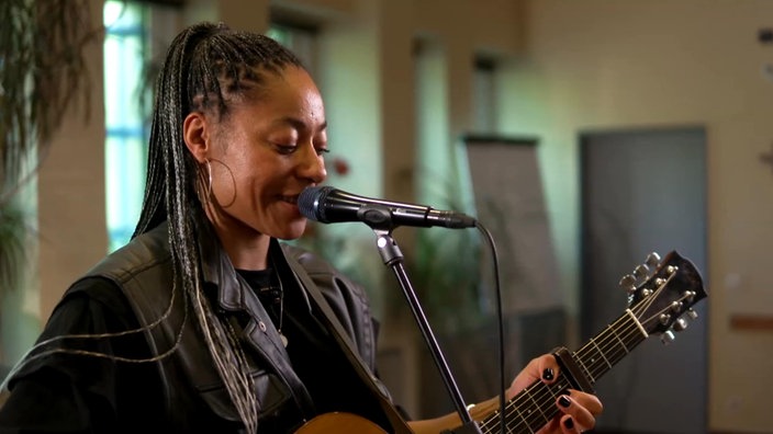 Diana Ezerex mit Gitarre beim Auftritt