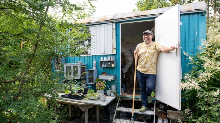 Peter Mecklenburg an seinem Atelier, einem alten Bauwagen.
