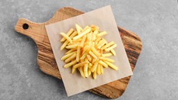 Pommes auf einem Holzbrett drapiert