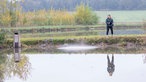 Svenja Viertel steht in einem Fischteich. 