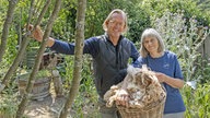 Frank Buchholz steht mit einer älteren Frau im Wald.