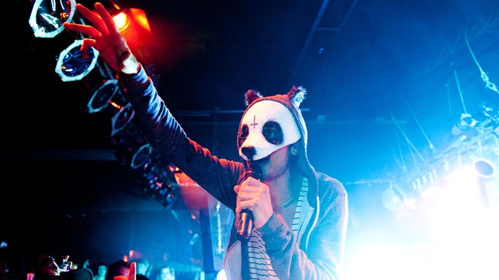 Rapper Cro hebt die Hand zu den fans