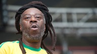  	Spencer „MC Spee“ Graham mit seinem Dreadlock Dutt