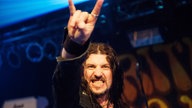 Sänger der Spiritual Beggars macht eine Rocker-Geste in die Kamera