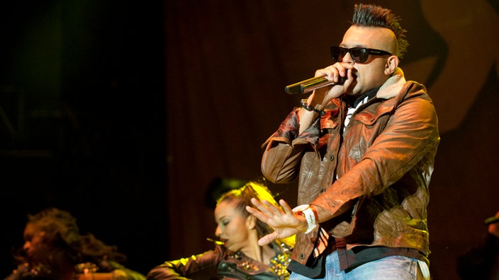 Bebrillter Sean Paul mit einer Motorradjacke