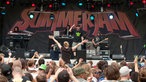 Eine Menschenmenge steht vor der Bühne und feiert den Aufttritt des Rappers und seiner Band