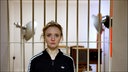 Frau vor Gitterstäben