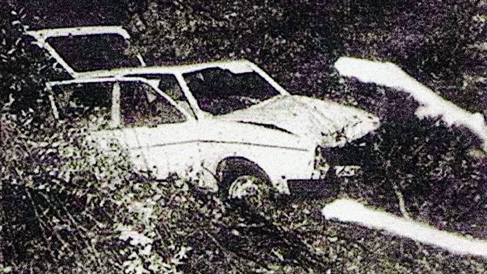 Der weiße VW Golf von Günter Stoll in einer Böschung neben der Autobahn. Er ist stark beschädigt.