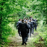 Ein Trupp Polizisten im Wald.
