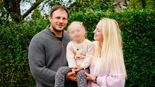 Julia und Oliver Korbach mit Tochter Nele auf dem Arm.