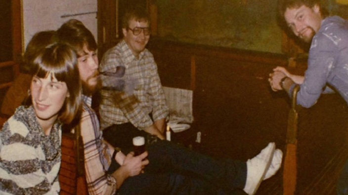 Auf dem Foto aus den 70ern sitzen junge Menschen auf den Straßenbahnbänken des in die Motorbar gebauten Straßenbahnwaggons.