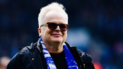 Sänger Herbert Grönemeyer mit Sonnenbrille und Fußballschal