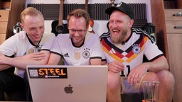 Djs sitzen vor PC lachend und produzieren WM-Song