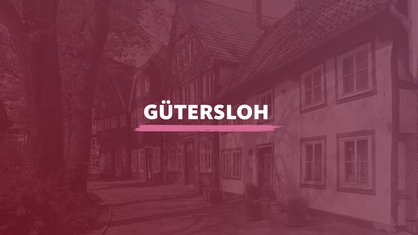 Ein Blick auf Fachwerkhäuser. Darüber der Schriftzug "Gütersloh".