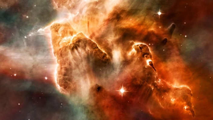 Eine Galaxie erscheint auf der Kuppel im Bochumer Planetarium als ein wolkenartiges rötlich gefärbtes Gebilde