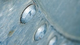 Eine Nahaufnahme einer Aluminiumoberfläche mit matten Oxidationsflecken
