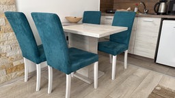 Esstisch mit vier blauen Polsterstühlen in einer modern eingerichteten Küche. 