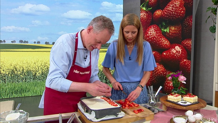 Marcel Seeger und Miriam Lange bereiten Quark-Mousse-Schnitten mit Erdbeeren vor