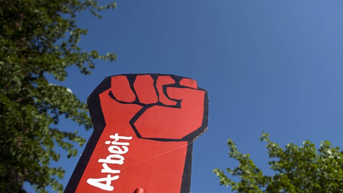 Eine rote Pappfaust mit der Aufschrift "Arbeit"