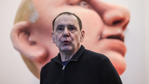 Jacyques-Tilly vor großem Putin-Gesicht
