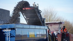Die abgefräste Deckschicht landet auf einem LKW