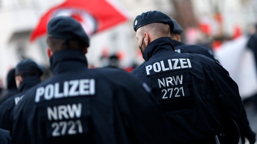 Ein Symbolbild zeigt zwei Polizisten von hinten.