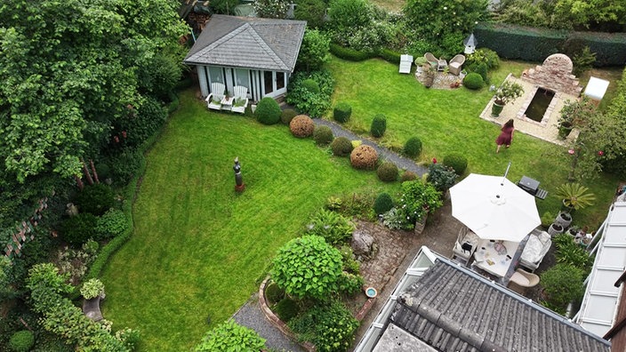 Aufsicht auf einen gepflegten Garten mit Gartenhäuschen