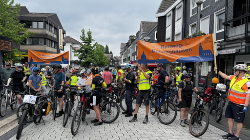 Menschen mit Warnwesten und Fahrrädern demonstrieren.