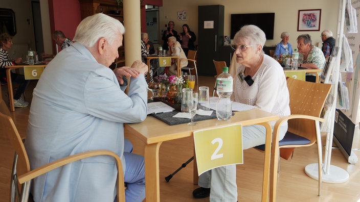 Zwei Senioren unterhalten sich beim Speed Dating