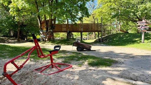 Spielplatz mit Sandkasten im Vordergrund