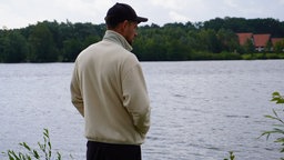 Matthäus Jastrzebski steht am Lippesee und blickt in Gedanken versunken auf das Wasser.