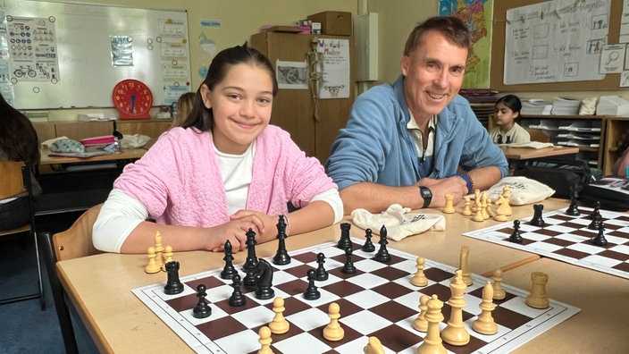 Celine und Schulassistent Uwe Beick spielen mit anderen Schülern in den Pausen Schach.