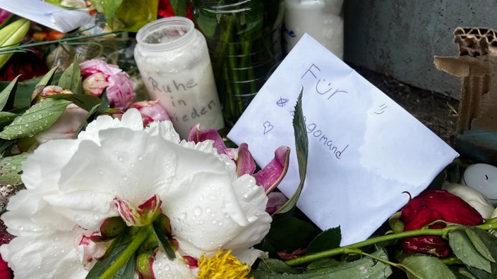 Eine Blume und ein Brief liegen auf dem Boden