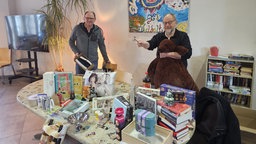 Verantwortliche der Weihnachts-Auktion präsentieren die Geschenke