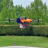 Eine Drohne die fliegt. Im Hintergrund sind eine Wiese, Bäume und eine Hecke zu sehen. 