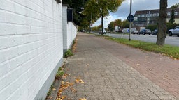 Gehweg an einer Straße neben einer Mauer