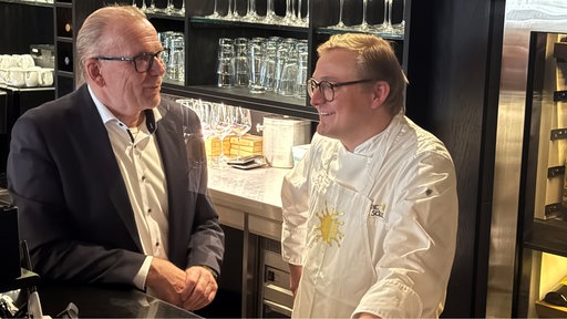 Torben und Bernd Tösing stehen hinter einer Theke
