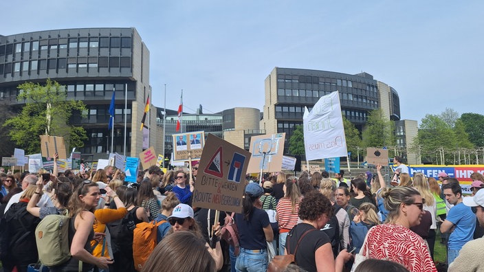 Viele Menschen stehen vor dem Landtag in Düsseldorf und halten Schilder in die Höhe