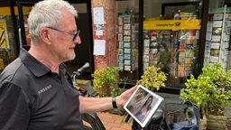 Ulrich Heidenreich schaut sich ein Foto von Anne Hathaway an.