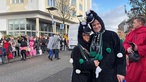 Zwei Menschen sind beim Veilchendienstagszug in Mönchenglabach als "Jünther" verkleidet