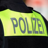 Symbolfoto: Der Schriftzug "Polizei" auf dem Rücken eines Polizisten.