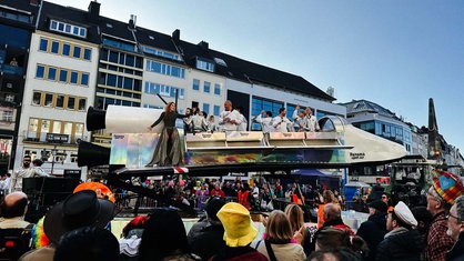 Ein Umzugswagen gestaltet als eine Rakete nimmt am Rosenmontagszug teil.