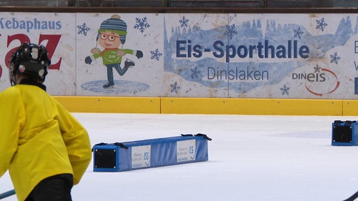 Die Eisfläche der Dinslakener Eissporthalle, auf der Außebegrenzung des Feldes ist zu lesen: "Eis-Sporthalle Dinslaken"
