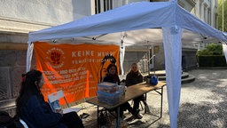 Feministische Aktivistinnen sitzen in einem Zelt neben dem Eingang des Dortmunder Landgerichts