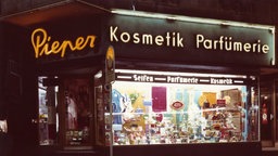 Aufnahme des Schaufensters der Filiale der Parfümerie-Kette Pieper in Herten im Jahr 1953, im Schaufenster stehen verschiedene Parfüms und Werbeposter