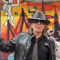 Udo Lindenberg vor einem Ausstellungsbild. 