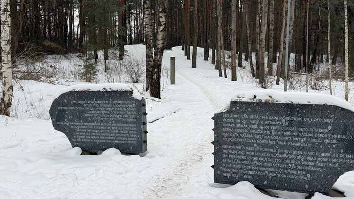 Zwei Gedenksteine in einem Wald bei Riga 